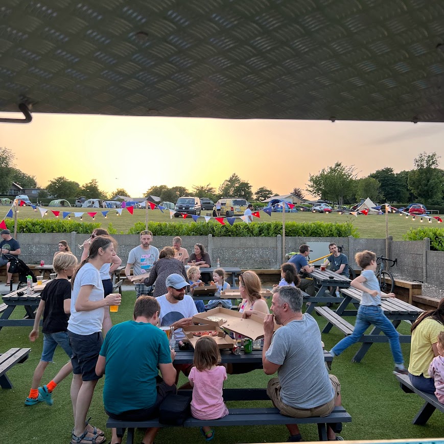Campers enjoying a drink in Sam's Bar seating area